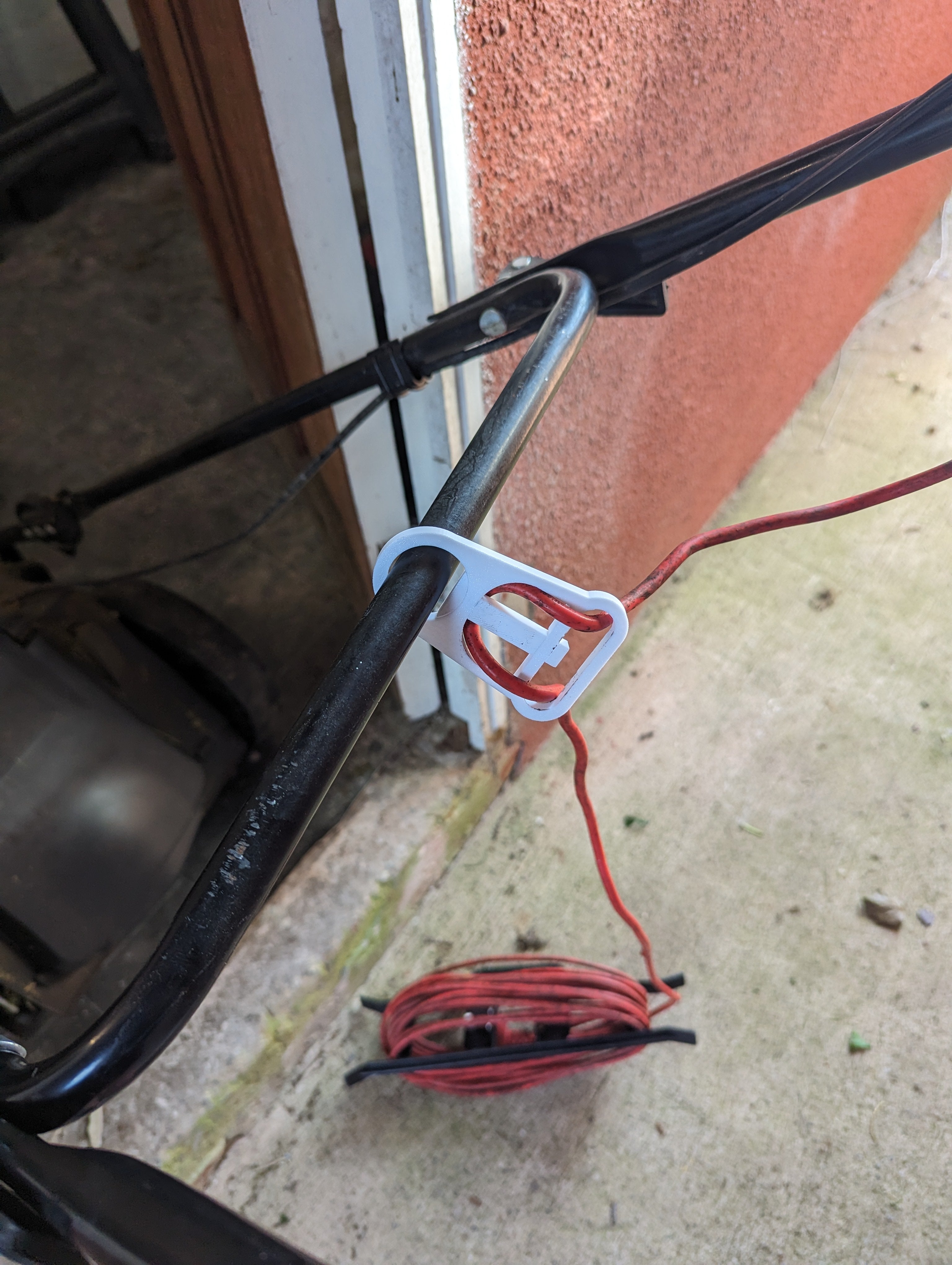 Support de câble pour tondeuse à gazon électrique