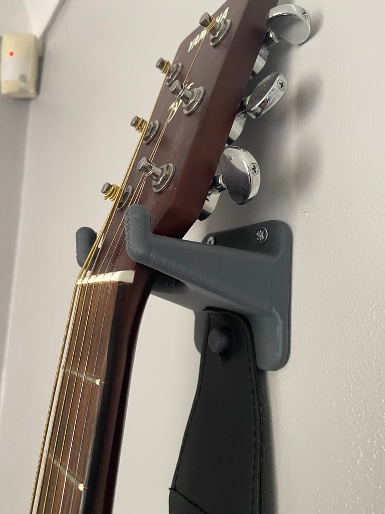 Support mural pour guitare avec espace pour médiators et sangle